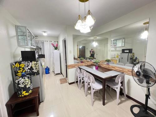 a kitchen and dining room with a table and chairs at One Oasis Condo 2 Bedroom Free Pool & Wifi Beside SM City Mall in Davao City