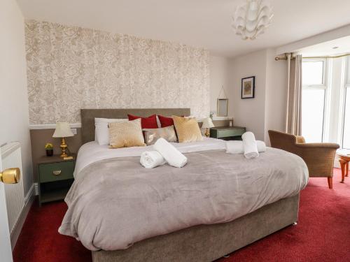 a bedroom with a large bed with white towels on it at Eden Bay Retreat in Morecambe