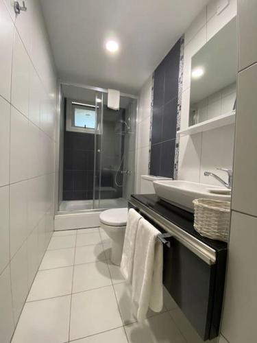a bathroom with a toilet and a sink and a shower at Private Flat in Famagusta Center with Hotel Perks in Famagusta