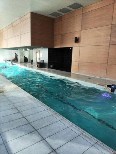 a person swimming in a swimming pool in a building at L6,1Min to SouthernCross, Free Tram,Pool,Gym in Melbourne