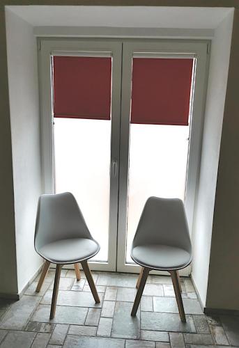 two chairs sitting in front of a window at Ferienhaus Emilia in Wilthen