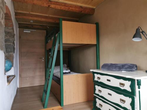 a room with a bunk bed and a desk at Ferienhaus Emilia in Wilthen