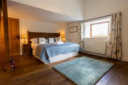 a bedroom with a bed and a window and a rug at Linton Laithe in Skipton