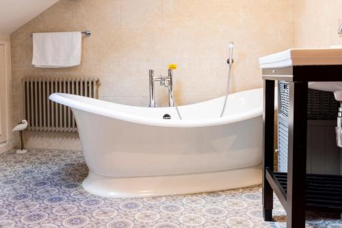 a large white bath tub in a bathroom at Linton Laithe in Skipton