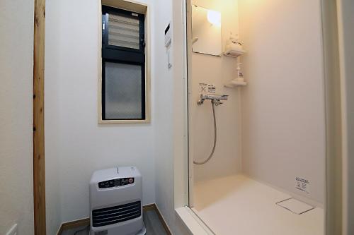 a bathroom with a shower and a toilet in it at TOKYO MY HOME in Tokyo