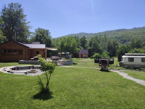 a yard with a rv and a rv and a building at Camp Lipovo in Kolašin