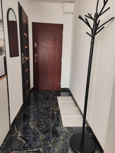 a hallway with a tree in front of a door at Súkromný luxusný apartmán in Hlohovec