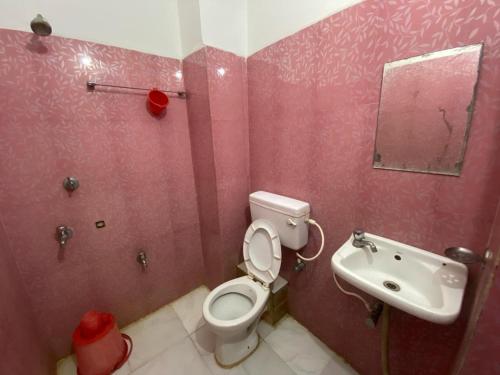 a bathroom with a toilet and a sink at Sandhya Guest House - Best Budget Hotel #New Digha in Digha
