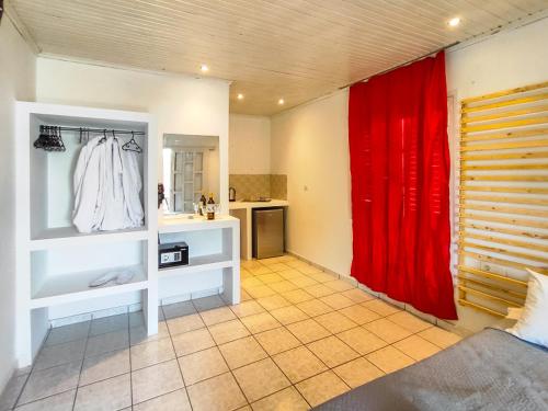 a bathroom with a red curtain in a room at Salty SeaShells Skiathos in Skiathos