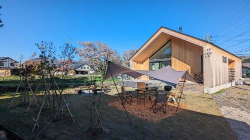 a small house with a tent in front of it at JOKIJOKI Hakuba in Hakuba