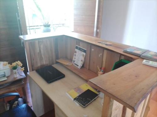 a wooden desk with a laptop on top of it at cyber city hotel kandy in Kandy