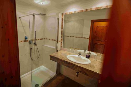 a bathroom with a sink and a shower at Hotel in the HEART of the Alps in Uttendorf