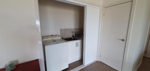 a small bathroom with a sink and a mirror at Ocean Mist in Port Fairy