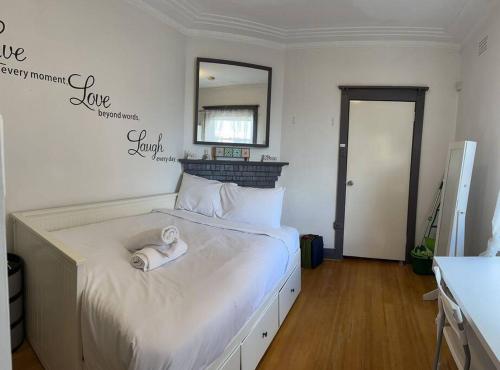 a bedroom with a bed with a towel on it at Budget 1 bedroom unit near Maroubra Beach in Sydney