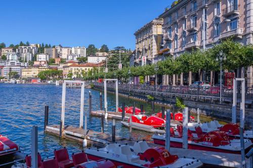 a group of boats are docked in the water at Magic Home - Happy Rentals in Viganello