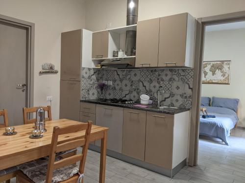 a kitchen with a table and a dining room at lake dreams in Verbania