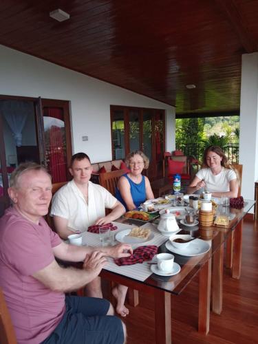 a group of people sitting around a table at The Tenthola in Kandy