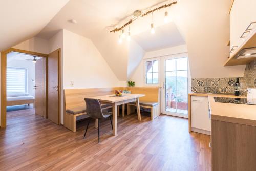 a kitchen and dining room with a table and chairs at Weingut Dietl in Riegersburg