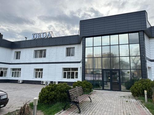 a building with a bench in front of it at ОРДА in Shymkent