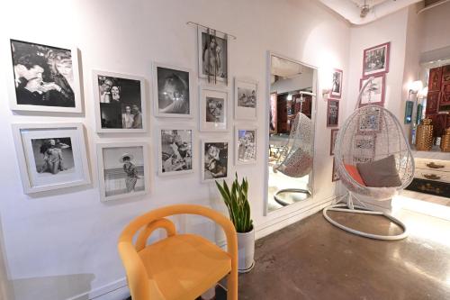 a room with pictures on the wall and a mirror at Mini Hotel Causeway Bay in Hong Kong