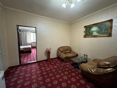 a living room with a couch and a chair at ОРДА in Shymkent