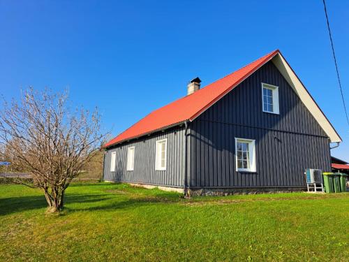 a black and red barn with a red roof at ZELTA KROGS 