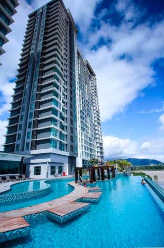 a large building with a swimming pool next to a building at LurrVe Dê' SĒÀ # Imperium Resident Kuantan in Kuantan