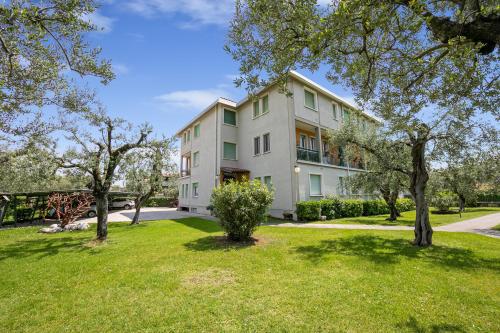 an apartment building with trees in the yard at Margherita near lake-child friendly - Happy Rentals in Toscolano Maderno