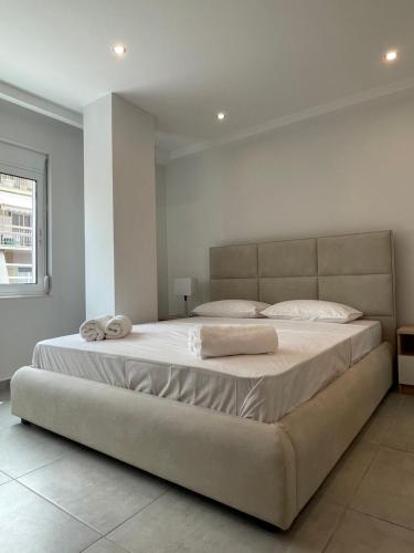 a bedroom with a large bed with two towels on it at Athenian Modern 2BD Apt next to Metro Panepistimio in Athens