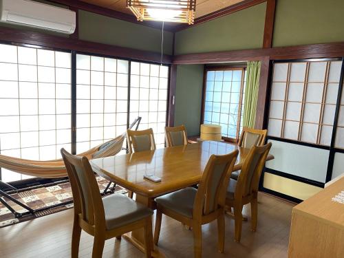 a dining room with a wooden table and chairs at Guest house Yamabuki - Vacation STAY 13196 in Toyama