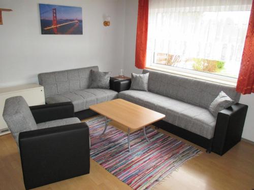 a living room with a couch and a table at Familienfreundliches Ferienhaus - b64026 in Marktgraitz