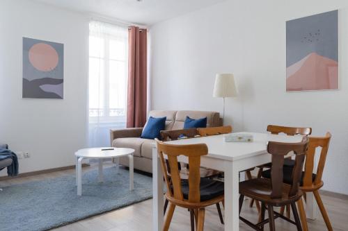 un salon avec une table et des chaises blanches dans l'établissement Travel Homes - Niffel 2 - Un havre de paix près du Parc, à Mulhouse