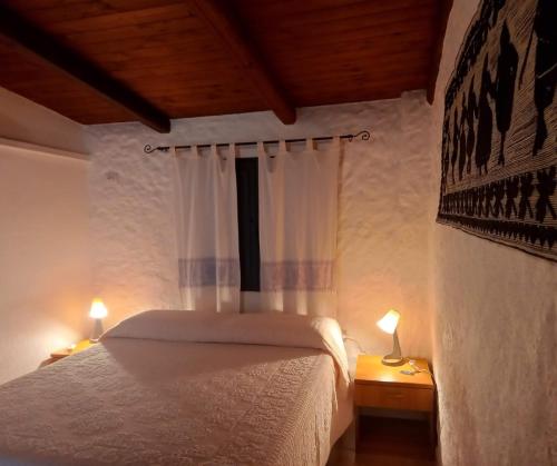 A bed or beds in a room at Agriturismo Su Cuile Countryside Comfort Rooms