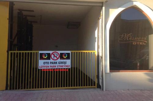 an open door of a building with a sign on it at Mesnevi Hotel in Konya