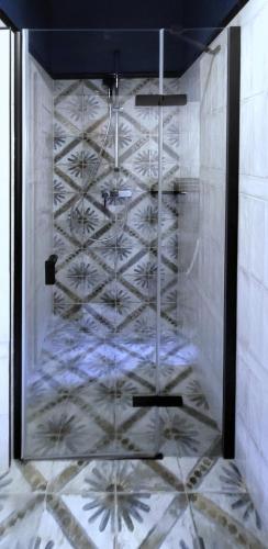 a shower with a glass door in a bathroom at Bunkr Karlštejn in Karlštejn