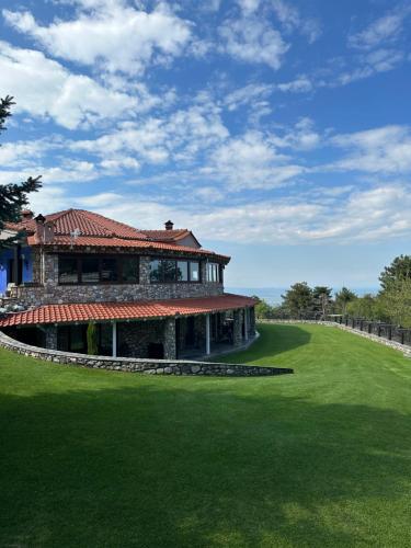 a large building with a green lawn in front of it at Ktima Faki in Litochoro