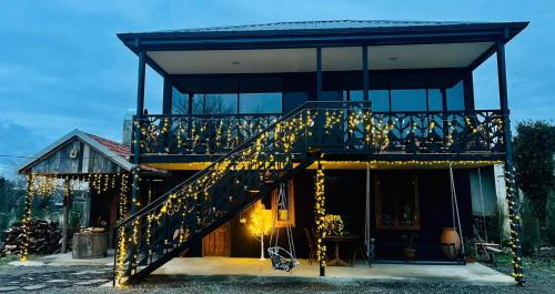 a house with a staircase with christmas lights at Odamarani in Kutaisi