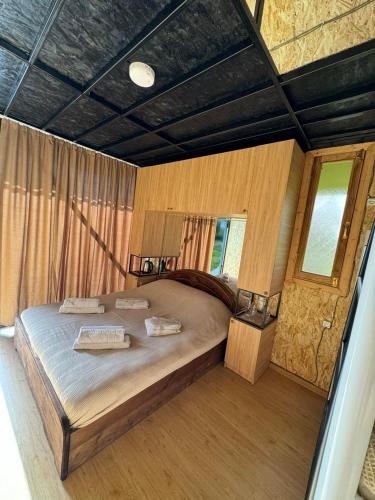 a bedroom with a large bed in a room at Odamarani in Kutaisi