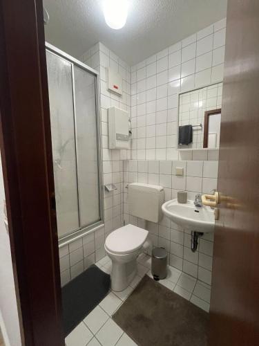 a bathroom with a toilet and a sink at Wegener Apartments in Mannheim