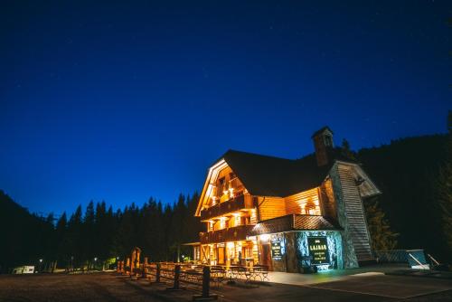 a large building with lights on at night at Guesthouse Lajnar in Zgornja Sorica