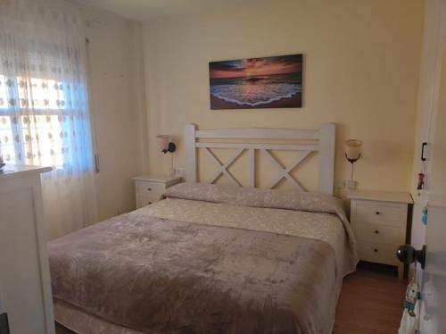 a bedroom with a bed and two tables and a window at Cèntric i tranquil a 1,7 kms de Port Aventura in Salou