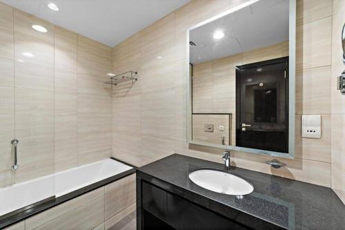a bathroom with a sink and a bath tub at Luxurious Studio with Stunning Views at Damac Celestia in Dubai