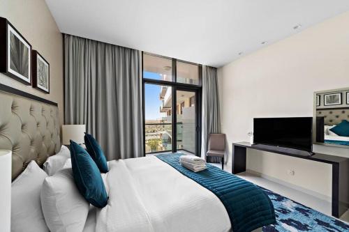 a bedroom with a large bed and a television at Luxurious Studio with Stunning Views at Damac Celestia in Dubai