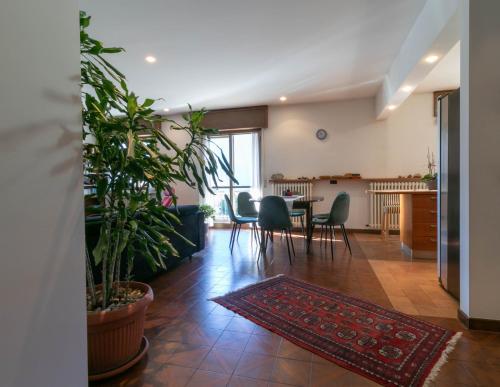 a living room with a table and chairs and plants at Welcomely - La Soliva Big House in Primaluna
