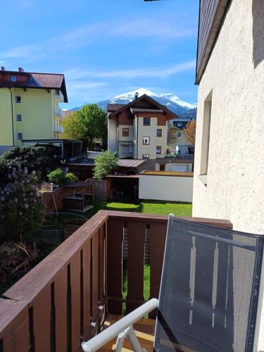 a chair on the balcony of a house at Haus Piller in Bad Hofgastein
