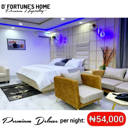 a bedroom with a bed and two chairs and a couch at D Fortunes Home in Asaba