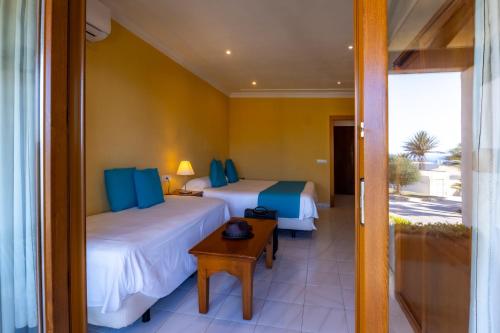 Letto o letti in una camera di Hotel Club Sunway Punta Prima