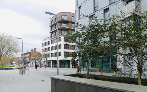um edifício numa rua com uma árvore em frente em Luxury Flat Town Centre em Reading