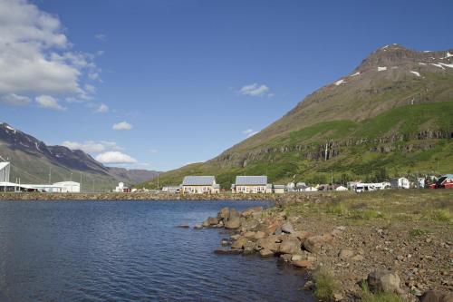 a body of water with a mountain in the background at Lónsleira Apartments in Seyðisfjörður