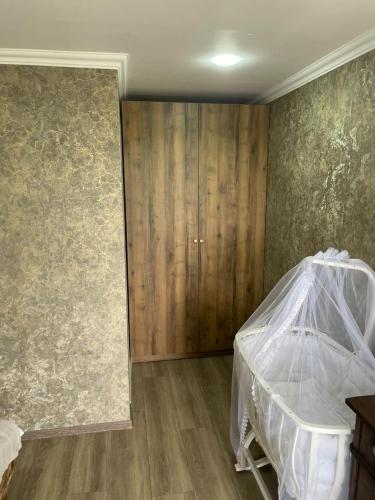 a bedroom with a bed with a mosquito net at Odamarani in Kutaisi